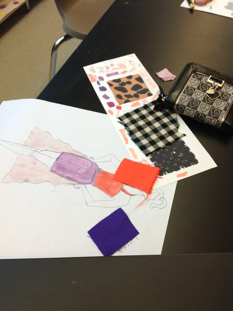 A group of students are working on a fashion design project.