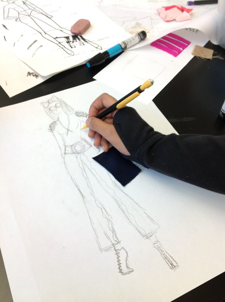 A person sketching a model with pencil