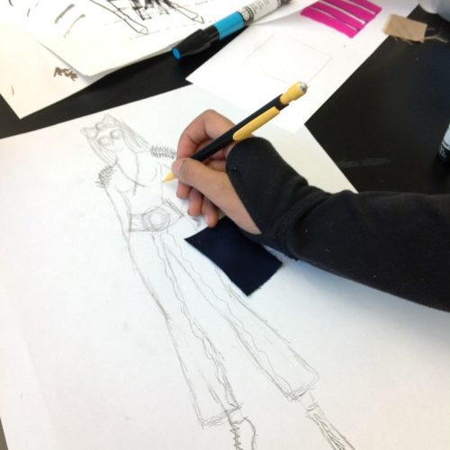 A person sketching a model with pencil