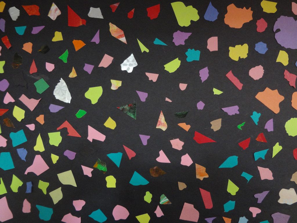 A collage of colorful pieces of paper on a black background.