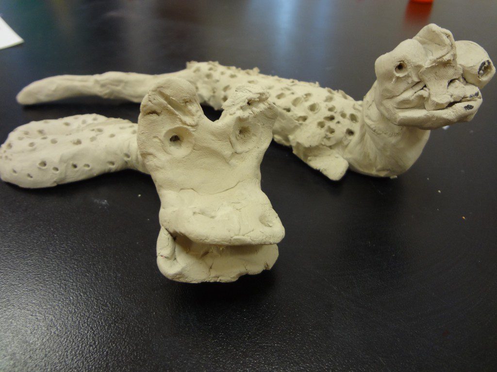 Clay sculptures of a crocodile and a lizard.