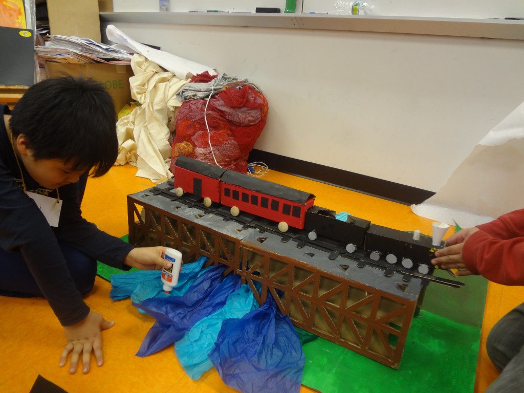 A boy is playing with a toy train.