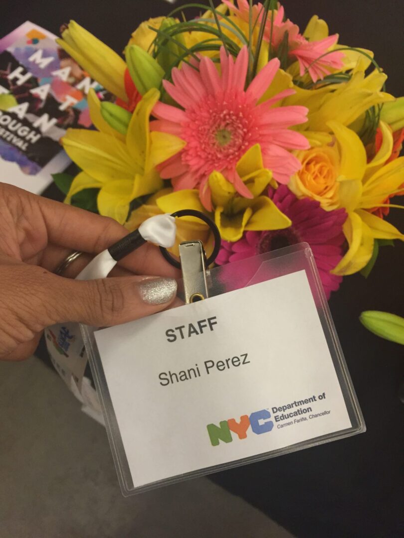 A person holding a staff id with flowers on it.