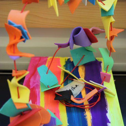 A colorful paper sculpture on a table.