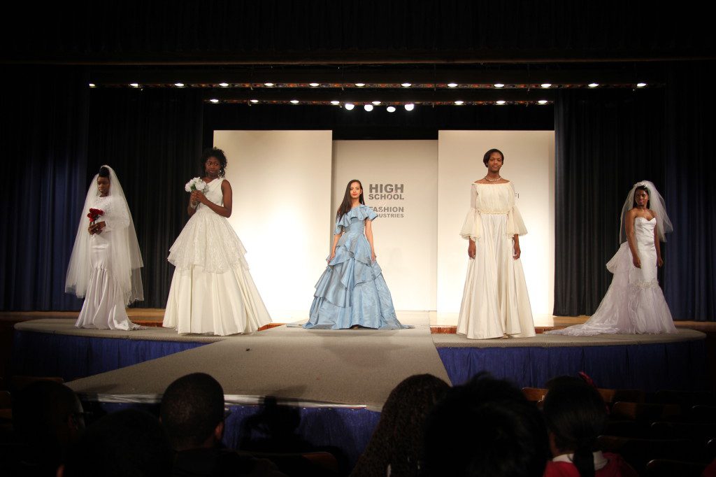 A group of women in wedding dresses on a runway.