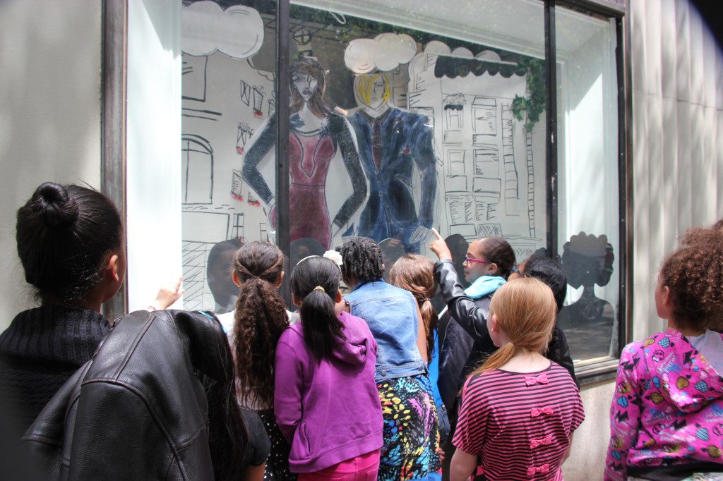 A group of children looking at a window display.