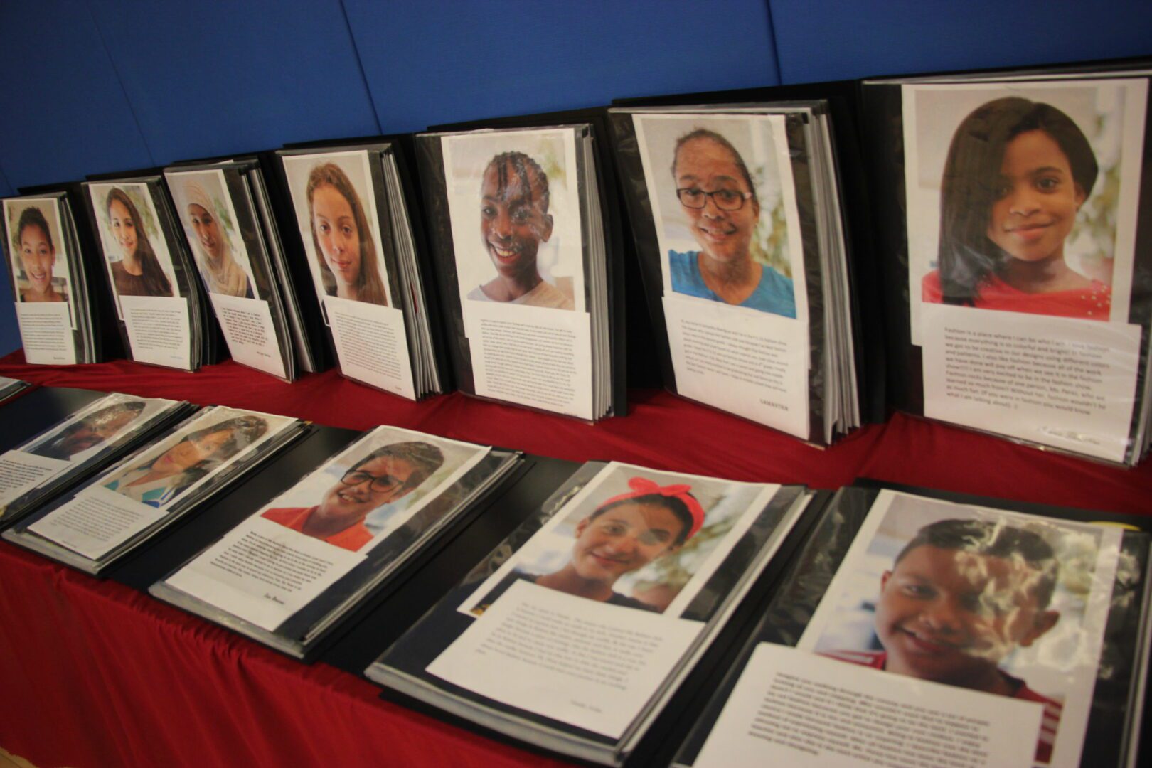 A display of photos of young people on a table.