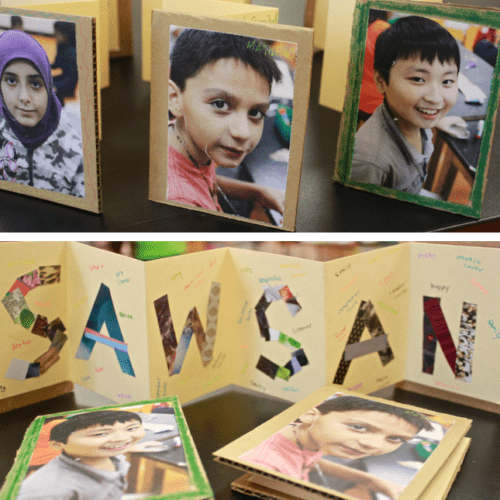 A group of children's pictures are displayed on a table.