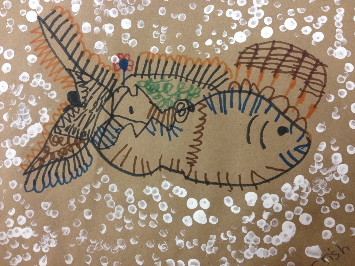 A drawing of a fish on a brown paper.