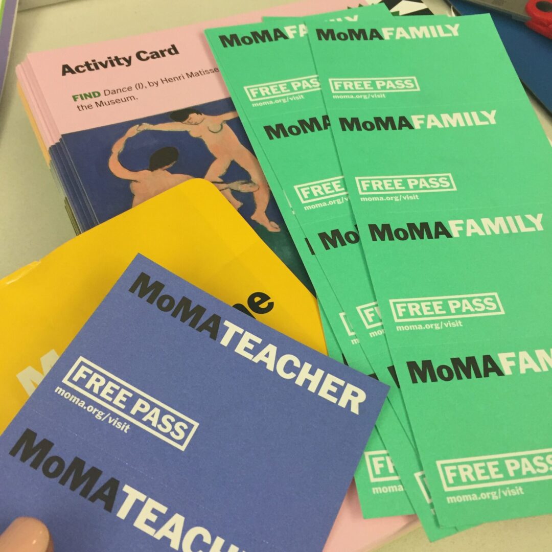 A group of people are sitting around a table with a mom teacher free pass.